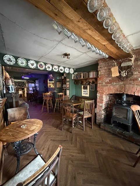 Front room with exposed brick fireplace